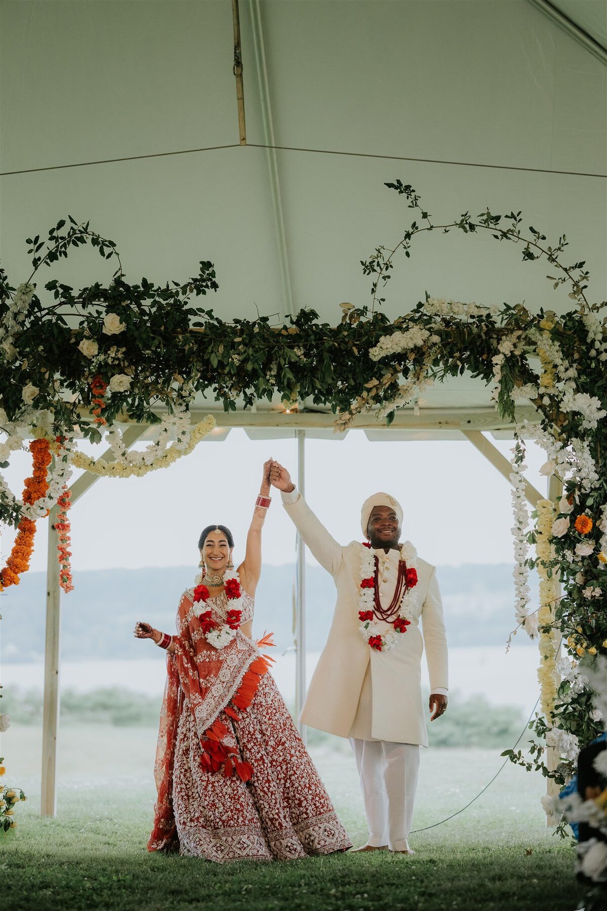 Indian Ceremony under a Mandap with greenery and flowers at Ankony Carriage House in the Hudson Valley