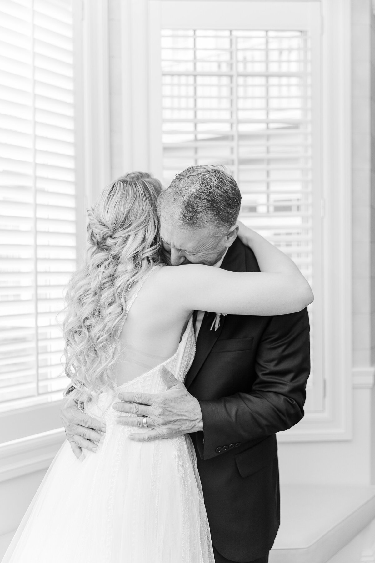 Bride hugs her father after he sees her for the first time. Captured by best New England wedding photographer Lia Rose Weddings.