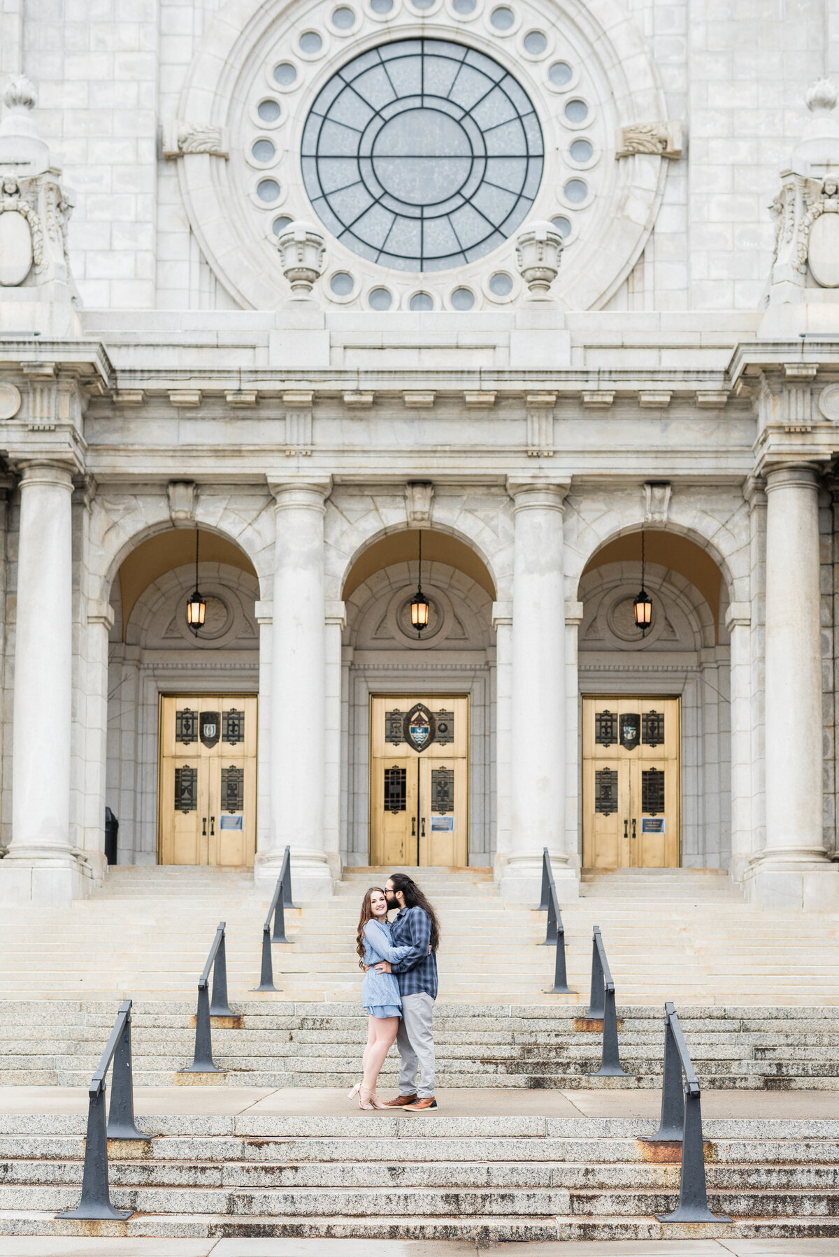 Couple standing and kissing in front of the Basilica of Saint Mary