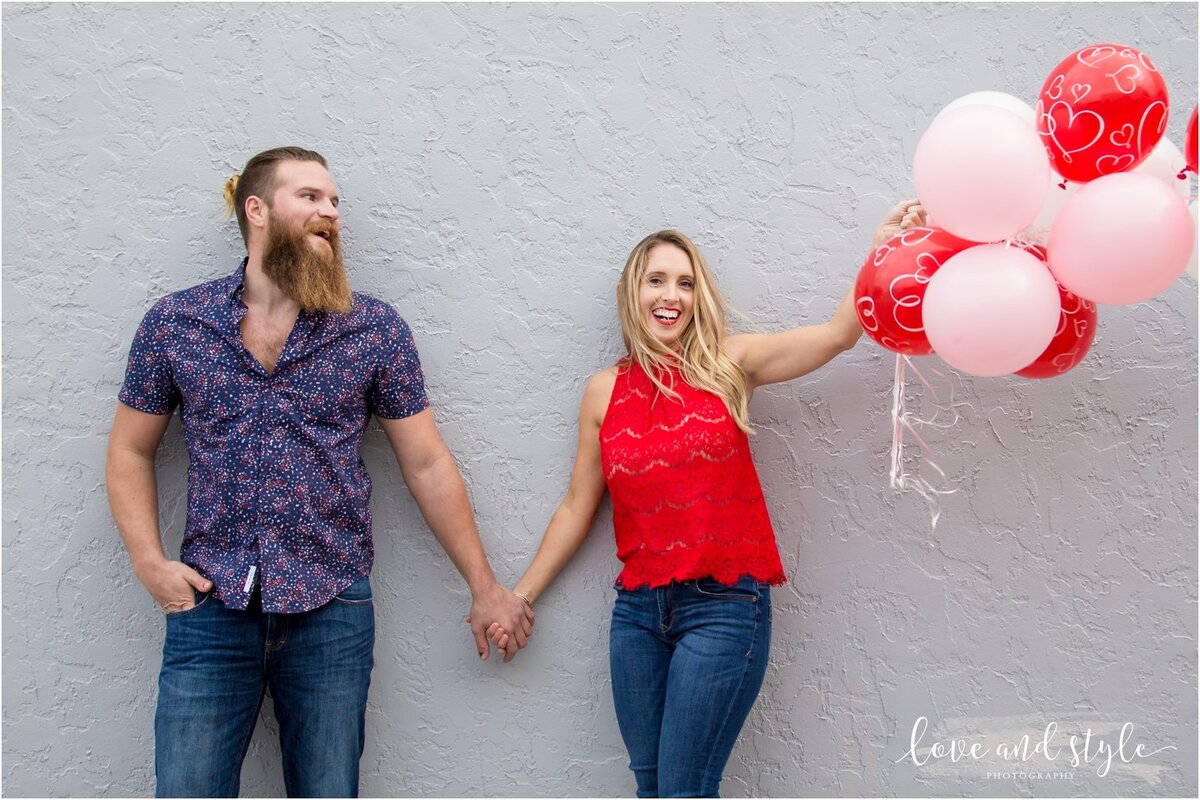 Engaged couple with red and pink balloons  downtown Sarasota on Valentines Day