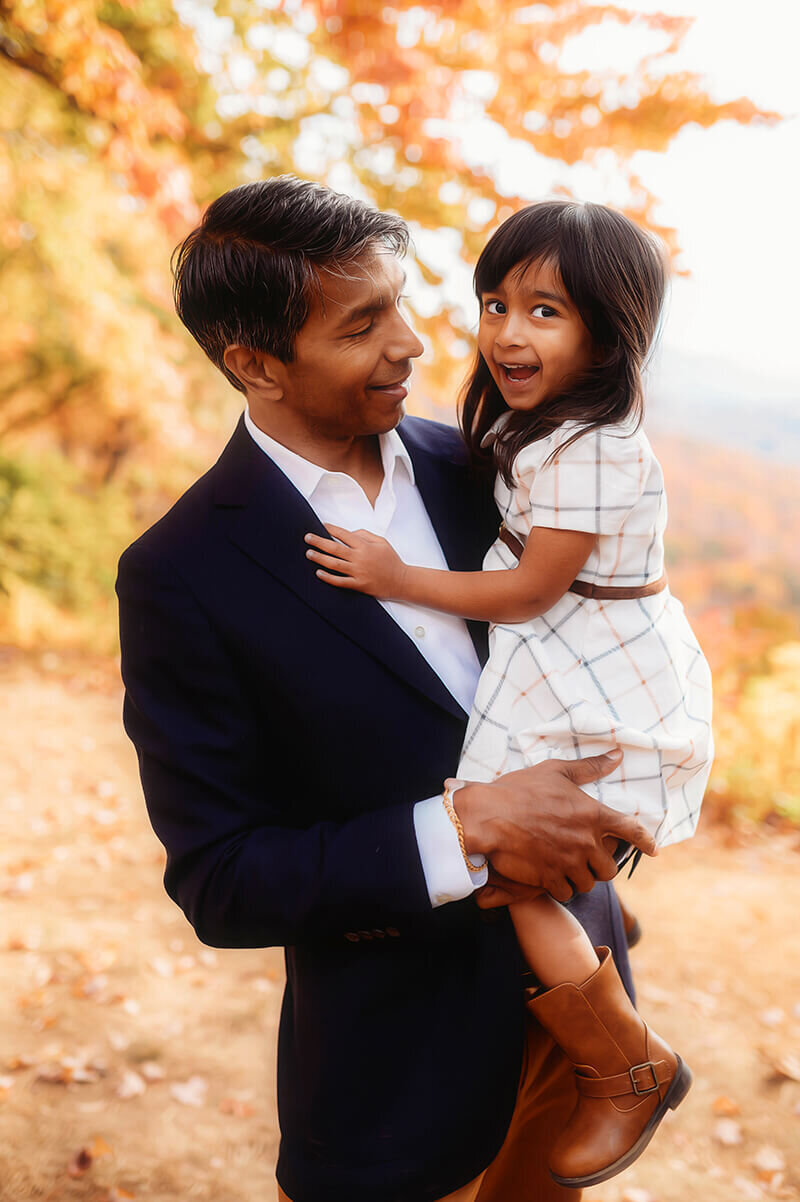 Father embraces his daughter during Family Photoshoot on the Blue Ridge Parkway in Asheville, NC.