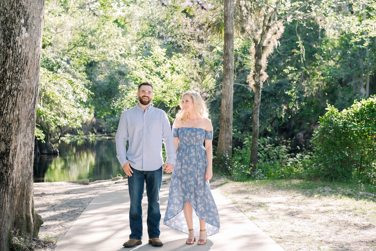 Cute couple holds hands during their hillsborough river state park engagement session