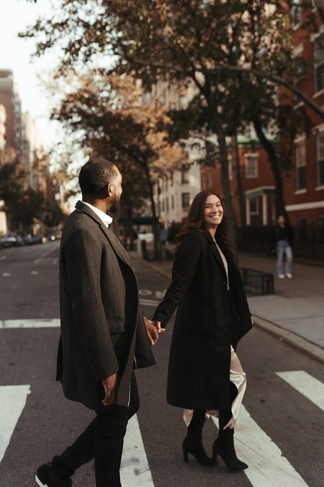 couple walking on crosswalk during engagement session