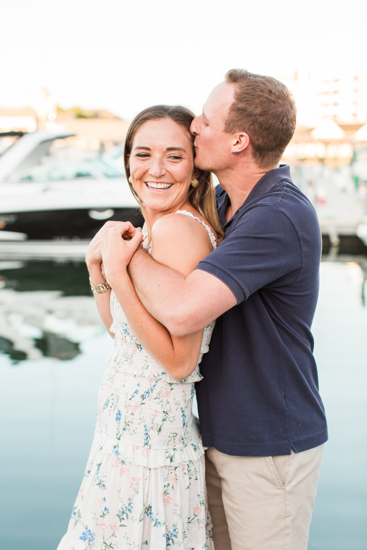 couple kissing in marina in Boston