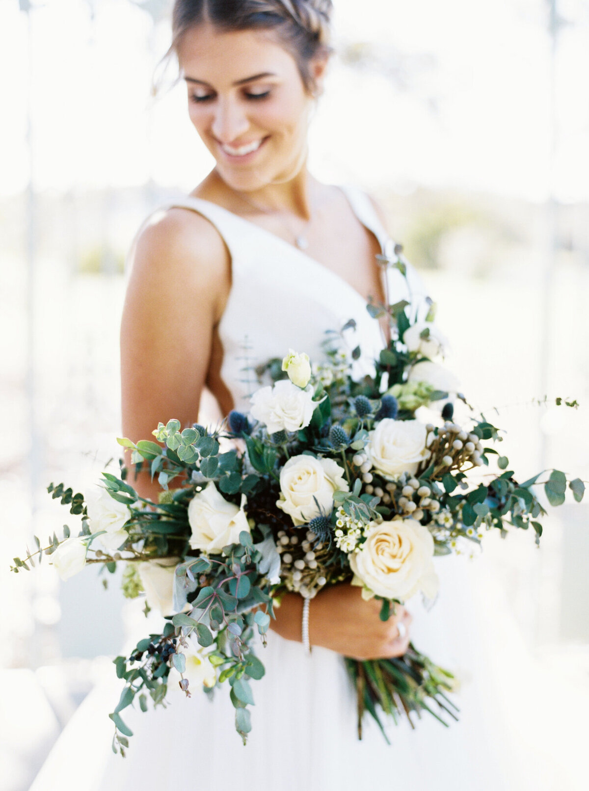 Bride holding white and cream bouquet