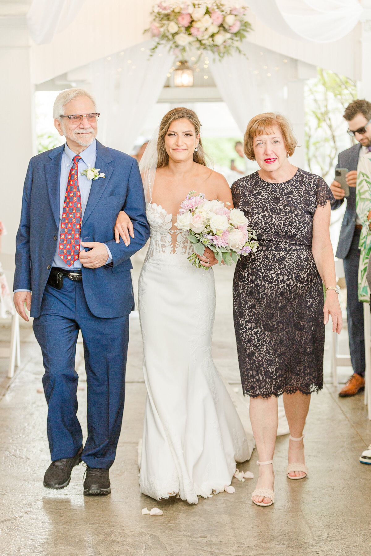 Bride's parents walk her down the aisle at the at the Five Bridge Inn. Captured by best Massachusetts wedding photographer Lia Rose Weddings.