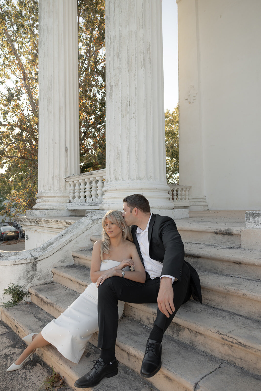 Couple sitting on stairs for charleston downtown engagament session
