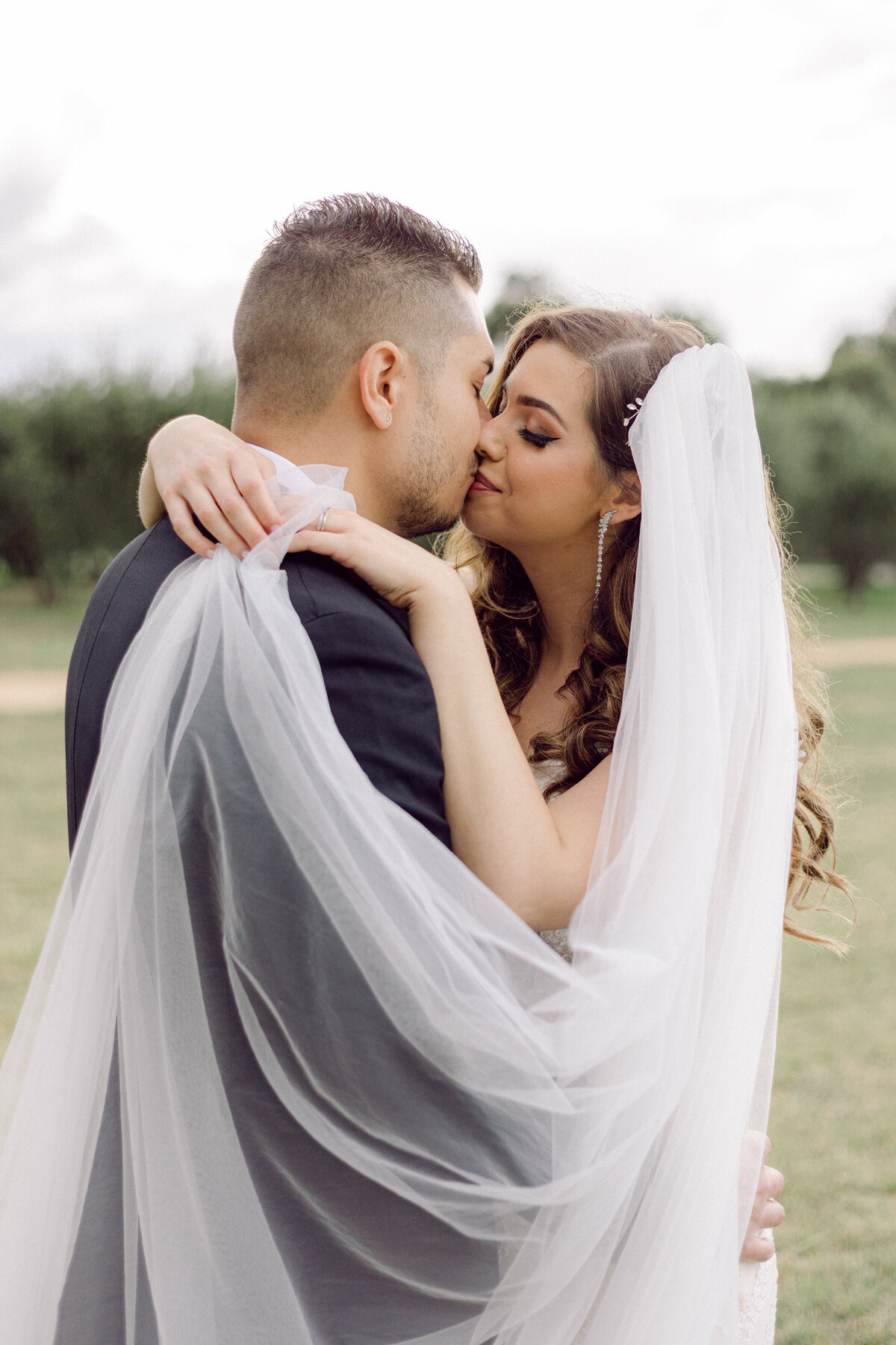Bride and Groom Kiss + Wedding Veil