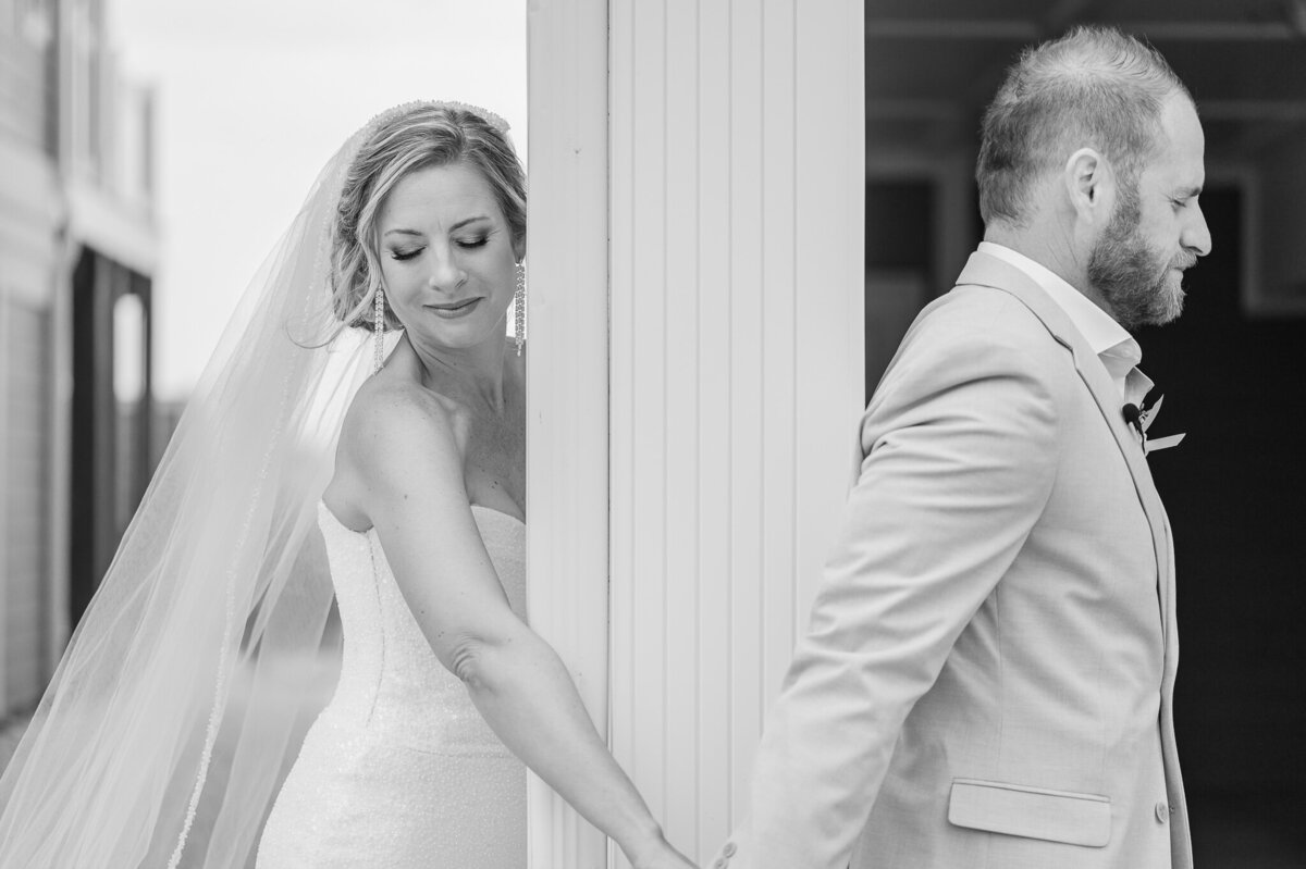 A couple on their wedding day sharing a prayer before their wedding ceremony while enjoying their Raleigh wedding photography session by JoLynn Photography