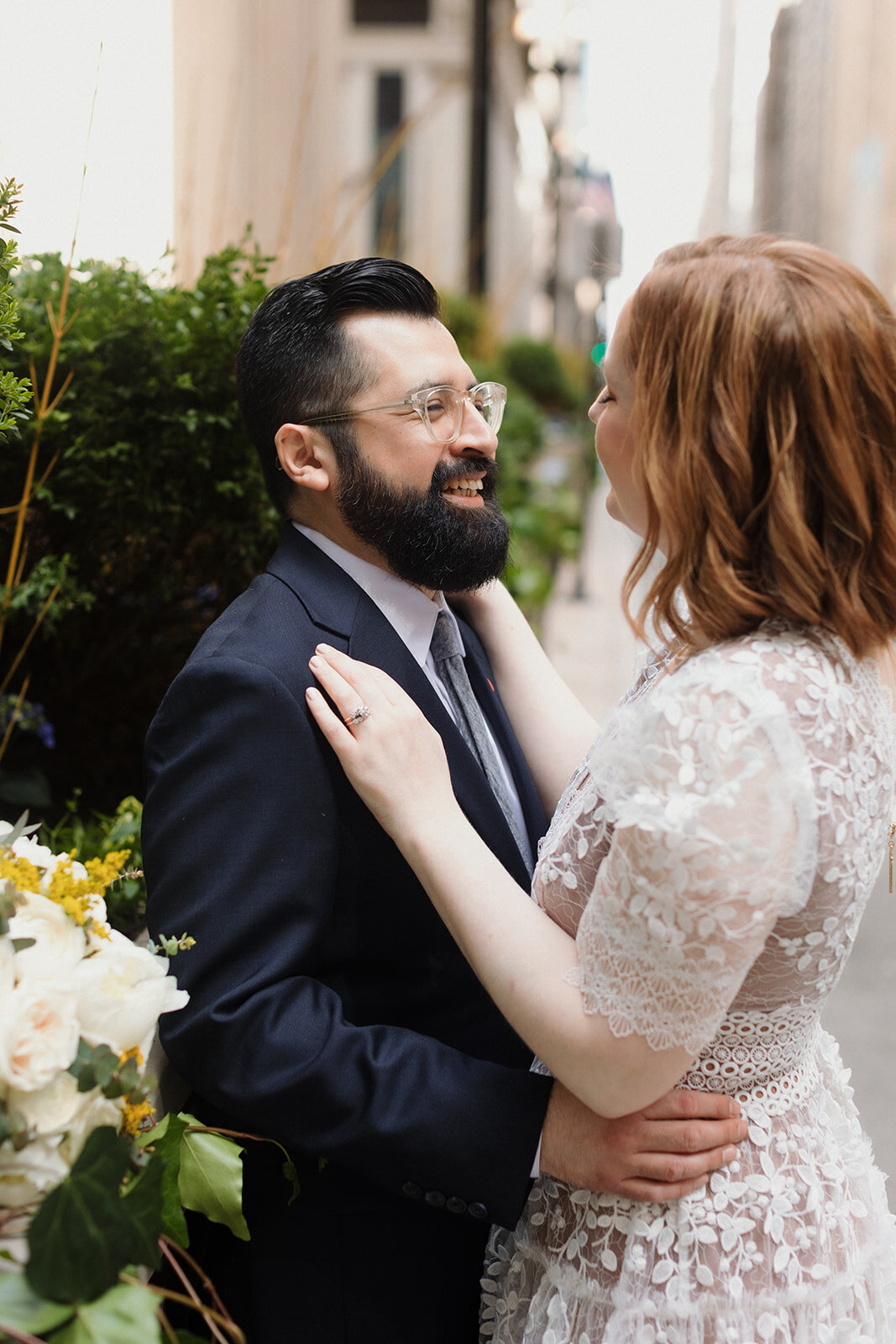 Elopement couple is very close and embracing on a street in Chicago.