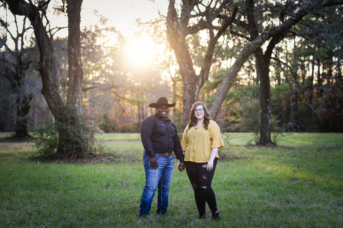 Beautiful Mississippi Engagement Photography: couple poses among oak trees at sunset