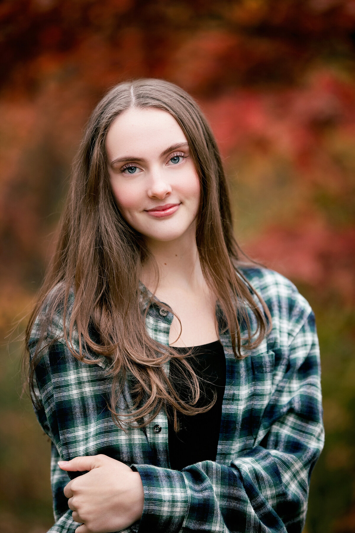 girl with plaid shirt on in fall