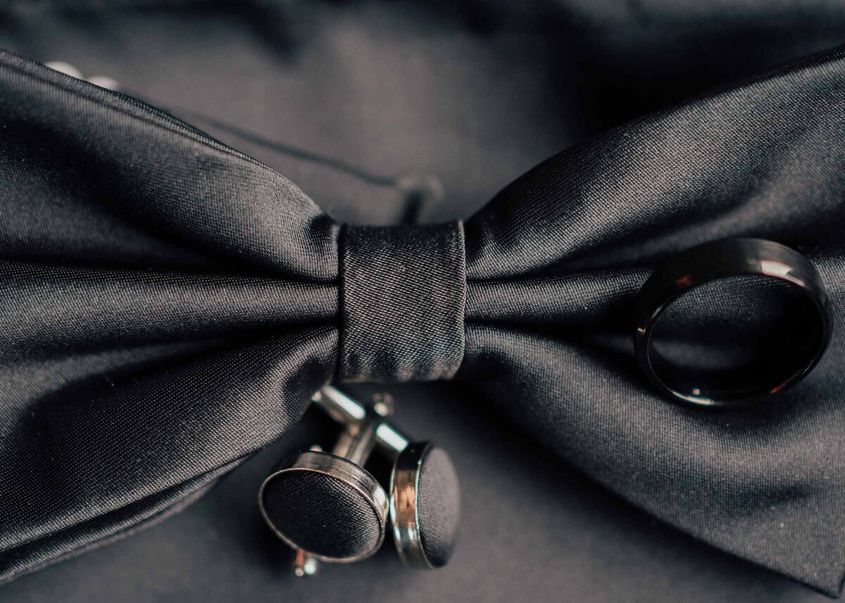 Maddie Rae Photography up close detail shot of the bow tie, cufflinks, and the grooms ring