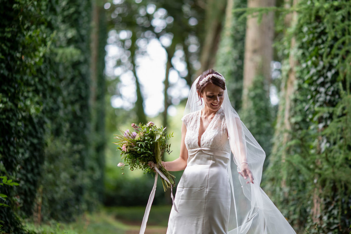Bride among the trees at Coombe Trenchard Wedding Devon