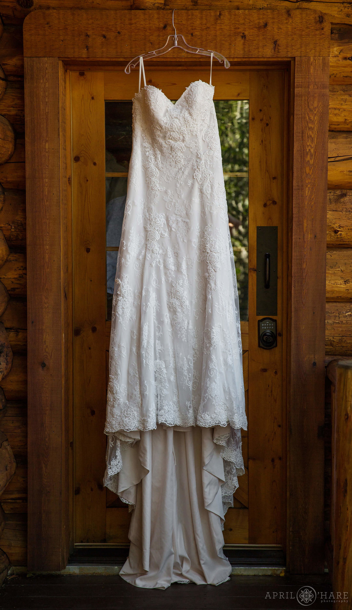 Colorado wedding photographer dress hangs in doorway in Silverthorne CO