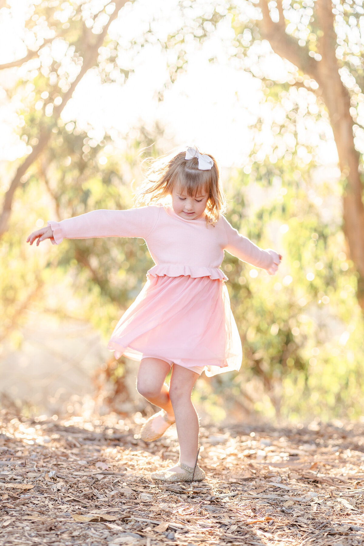 little girl twirling in a pink dress