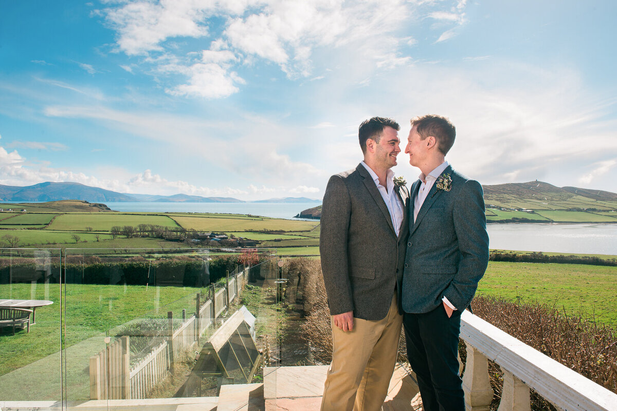 Gay grooms on terrace in Dingle overlooking the sea
