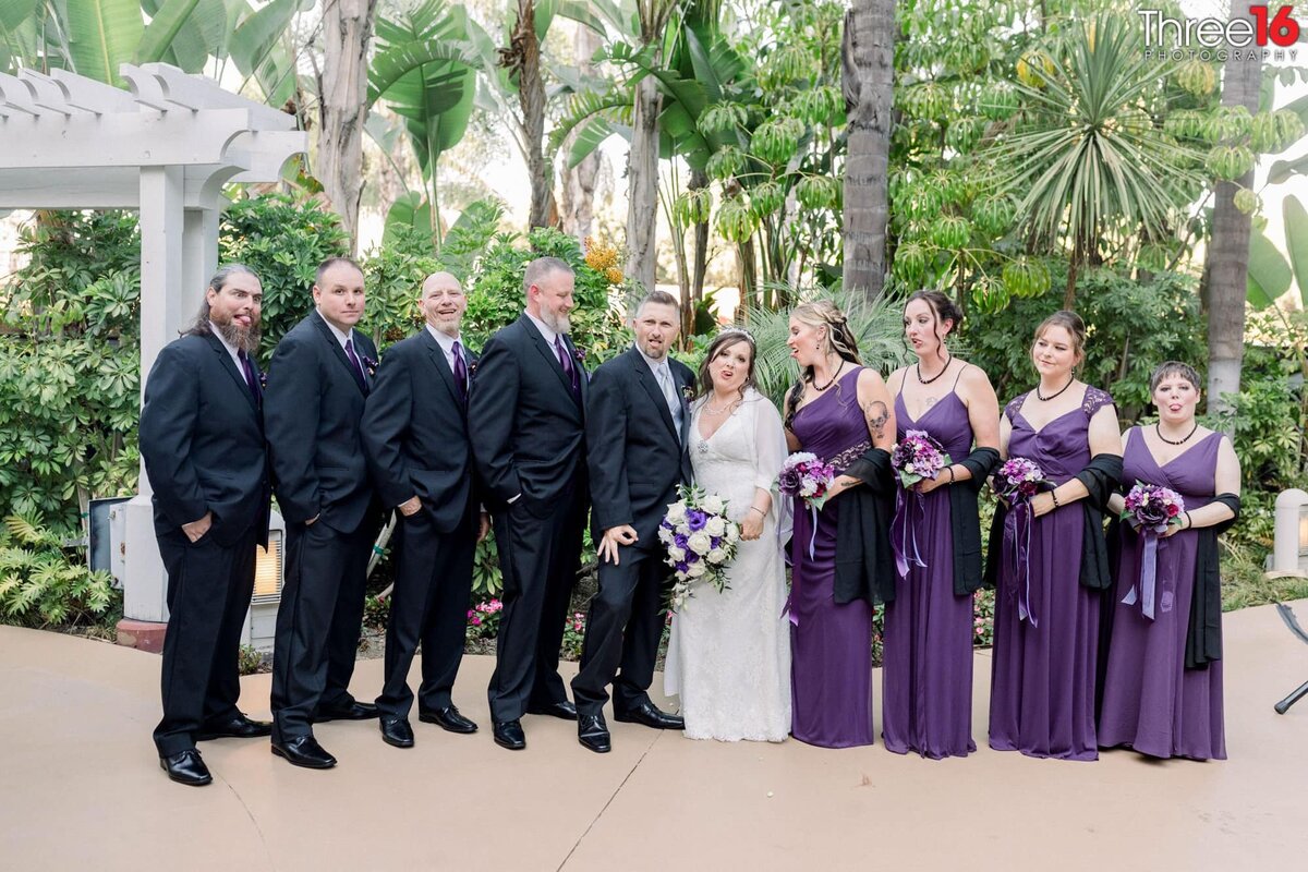 Bridal Party makes silly faces posing with Bride and Groom