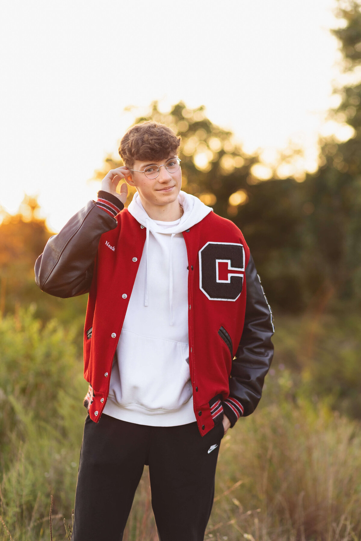 boy in letterman jacket with glasses