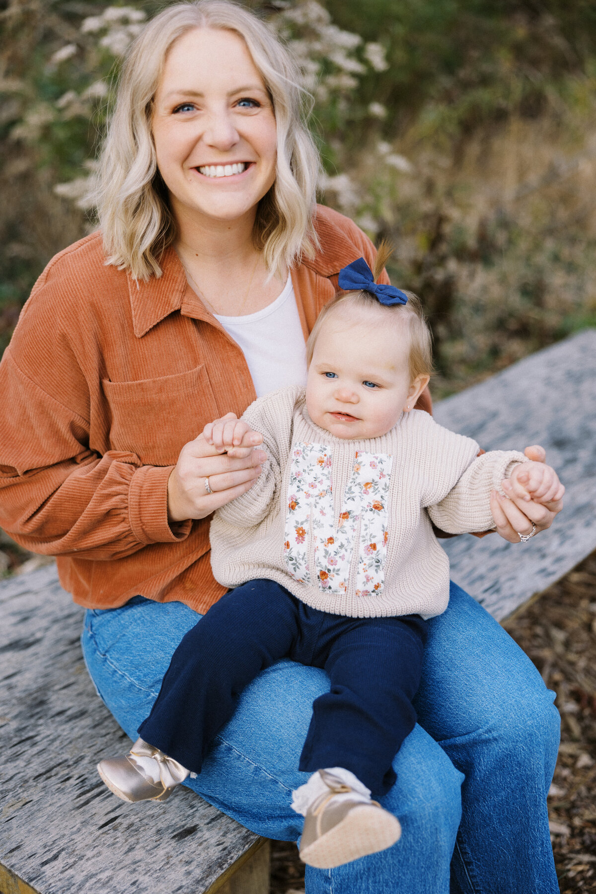 mom holding baby girl during family photos in Indianapolis