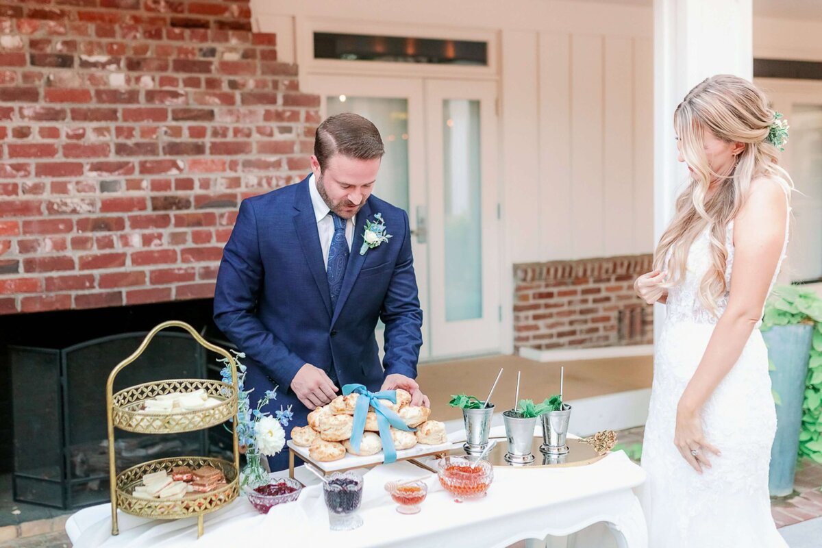 bride and groom at sweets table