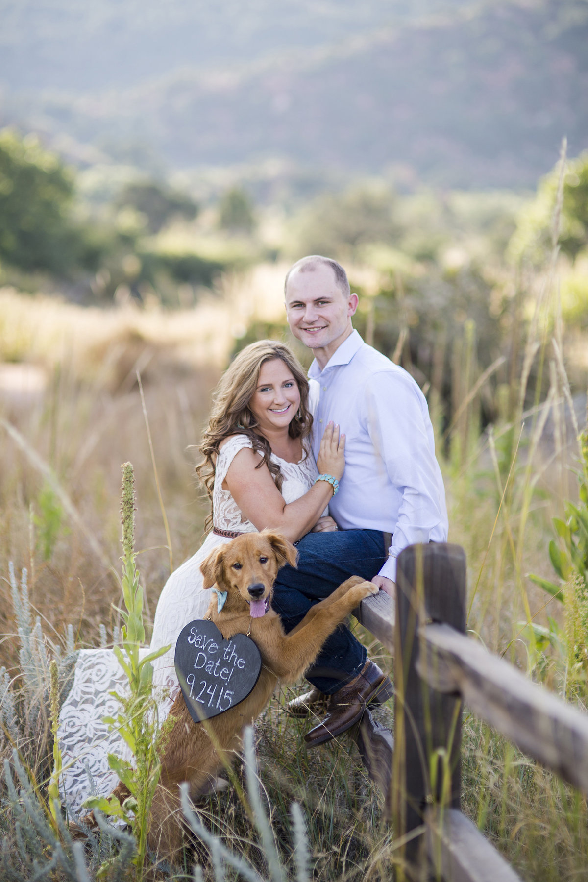 engaged couple with save the date and dog