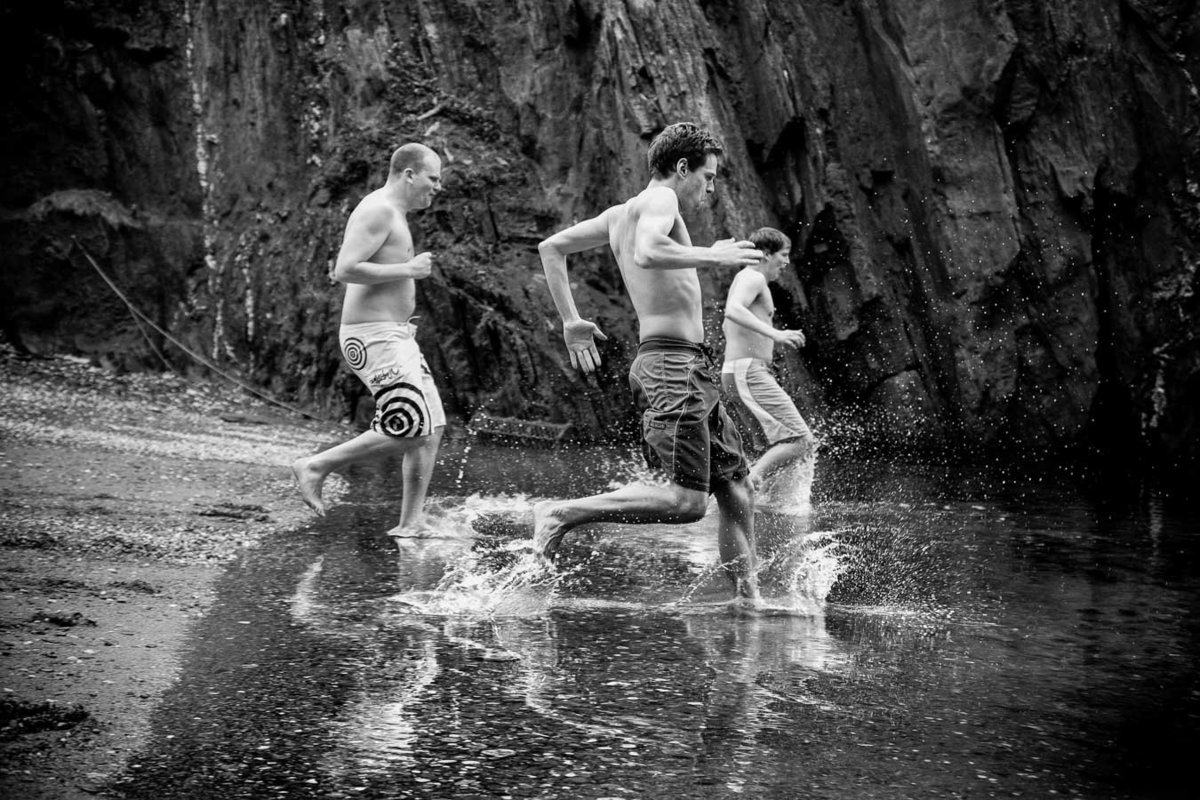 Groom and Groomsmen going for a swim at Tunnels Beaches in Devon