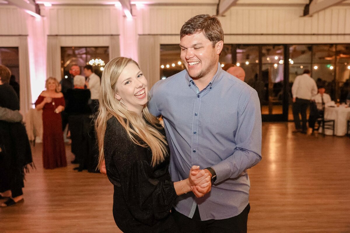 Fort Worth wedding photographer captures couple dancing at reception warm light blonde hair
