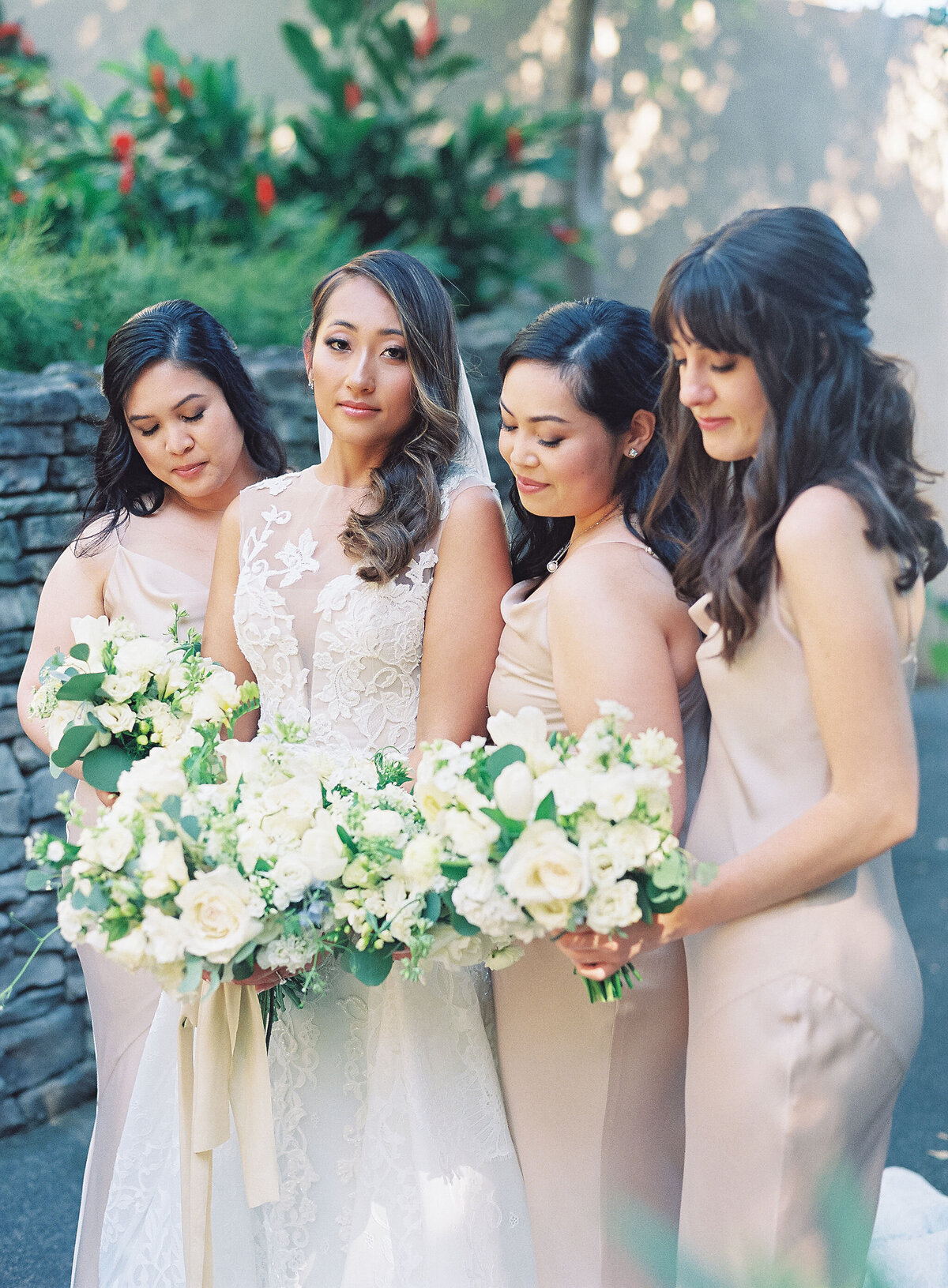 Bride and bridesmaids with hair and makeup styled