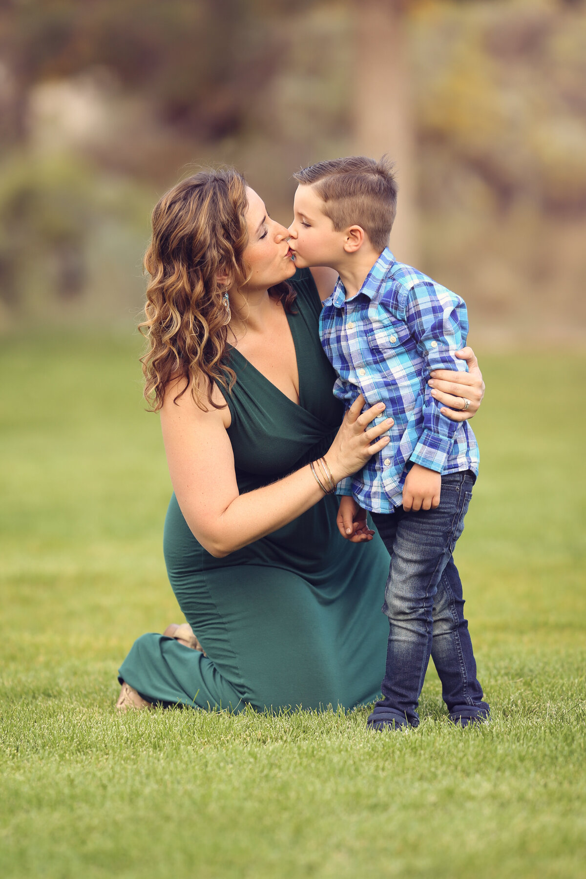 Yvonne-Min-Family-downtown-Photos-outside-natural-light-park-trees-sunset-photography-denver-thornton-broomfield-green-dress-mom-kiss-portraits-session-westminster-north-colorado-hug-boy-son-commons-setting-grass-connection-love-arvada-boulder-6