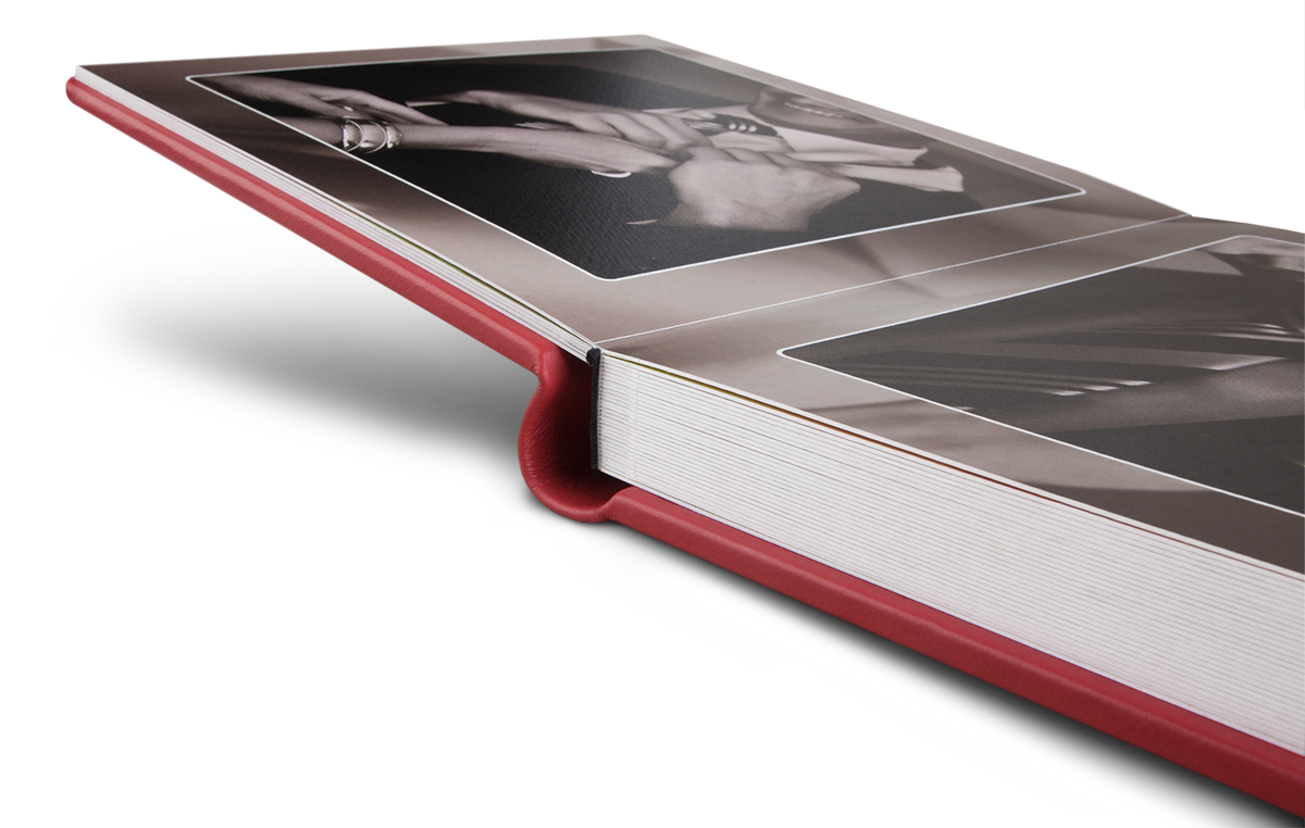 Lay flat wedding album with red leather cover.