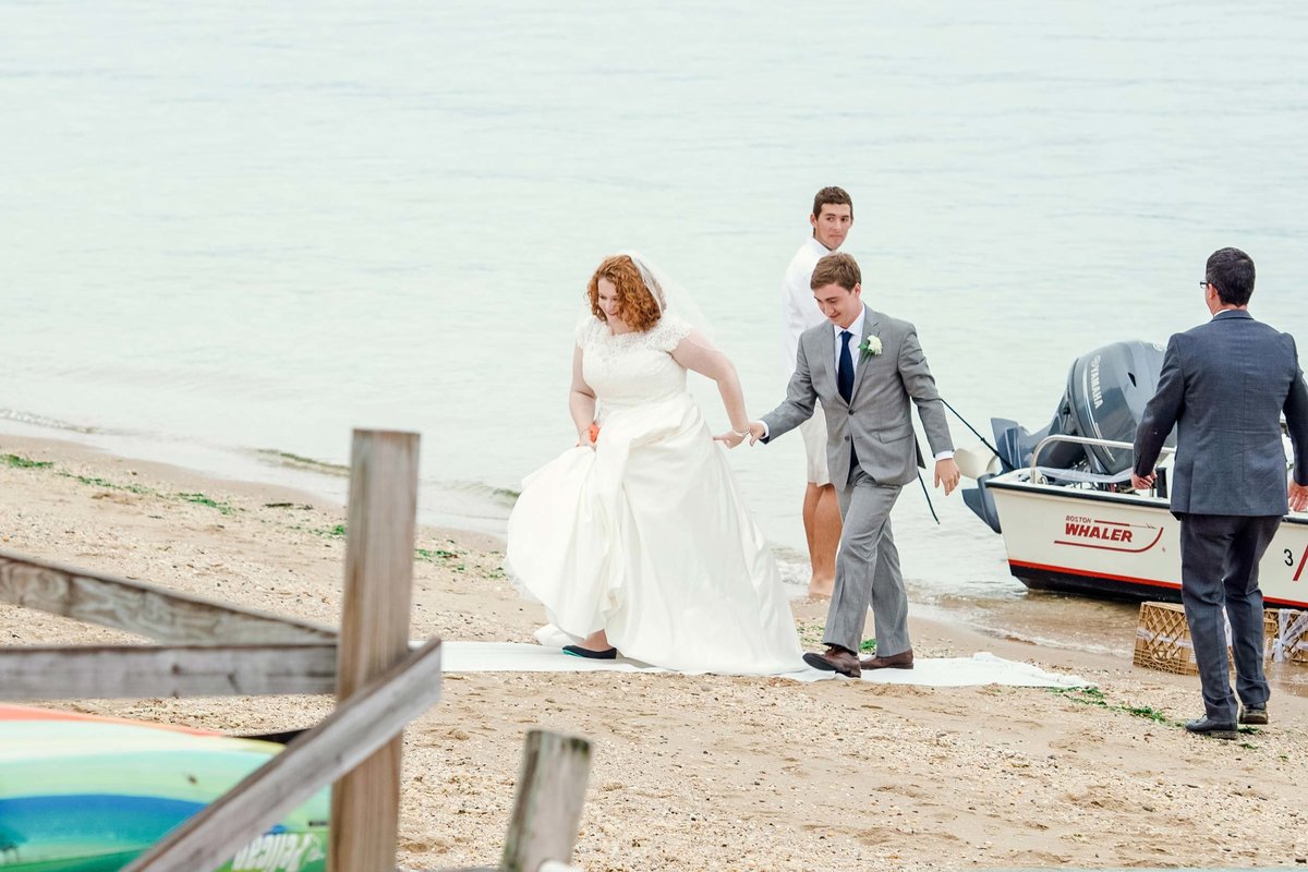 Bride and groom walking by dock at Head of the Bay Club