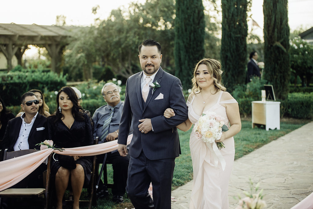 Wedding Photograph Of Groomsman And Bridesmaid Walking Down The Aisle Smiling Los Angeles