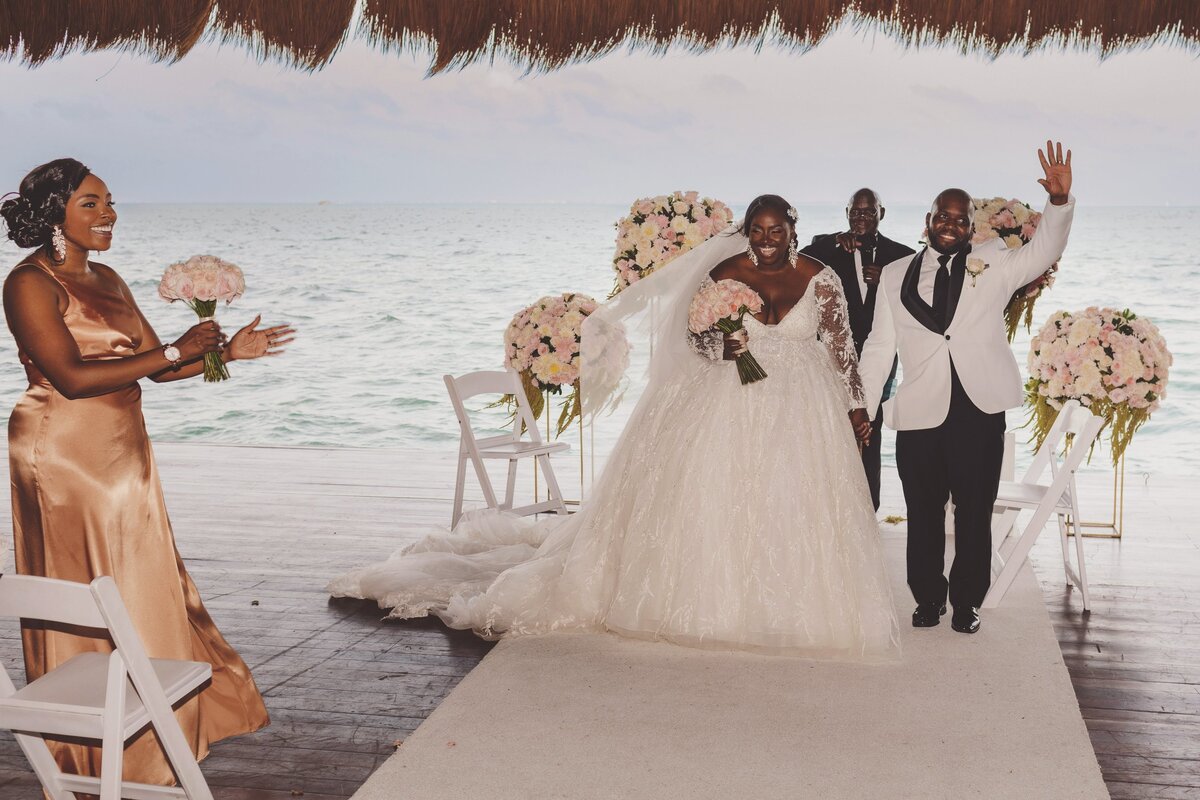 Bride and groom celebrate after wedding in ceremony in Cancun.