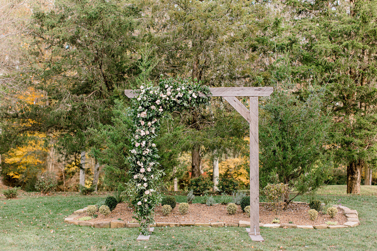 Wedding arbor at Cedarmont farm in lush greenery and white and pink flowers
