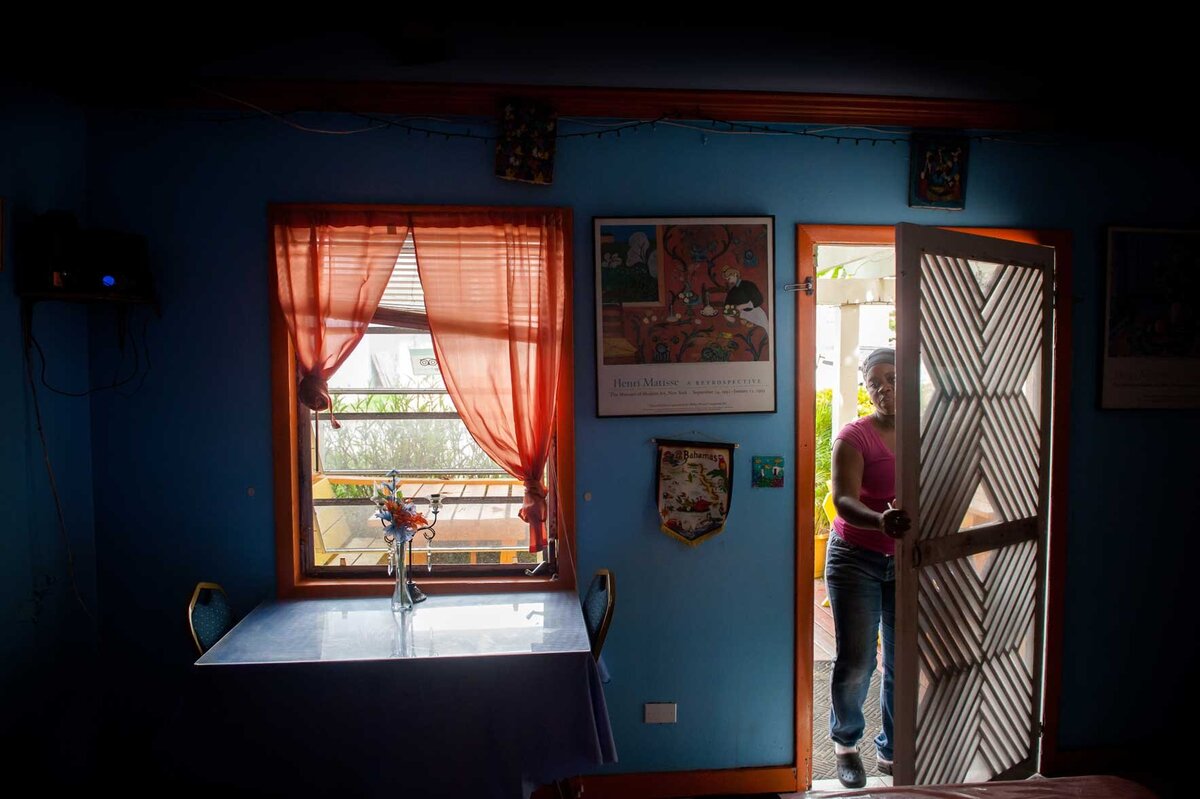 A women walks into a breakfast house on Harbour Island. Island culture tourism photos.