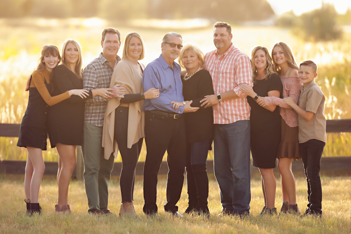 Family-Photos-yvonne-min-photography-parents-sister-brother-holding-hands-outside-field-golden-hour-sunset-connection-love-thornton-mckay-lake-broomfield-north-denver-erie-westminster-canon-session-images-fence-arvada-boulder-grass-sunlight-43
