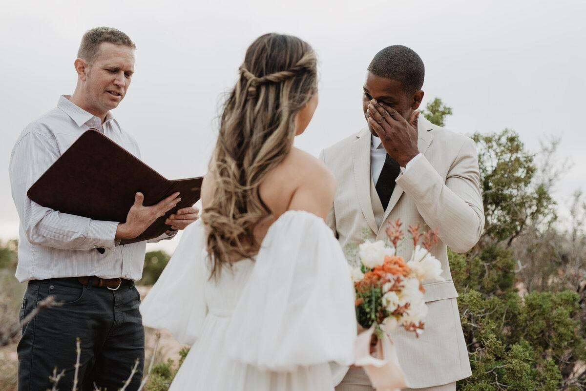 Utah Elopement Photographer captures groom wiping tears