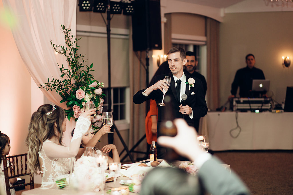 Wedding Photograph Of Groom Looking At His Bride While Raising His Wine Glass Los Angeles