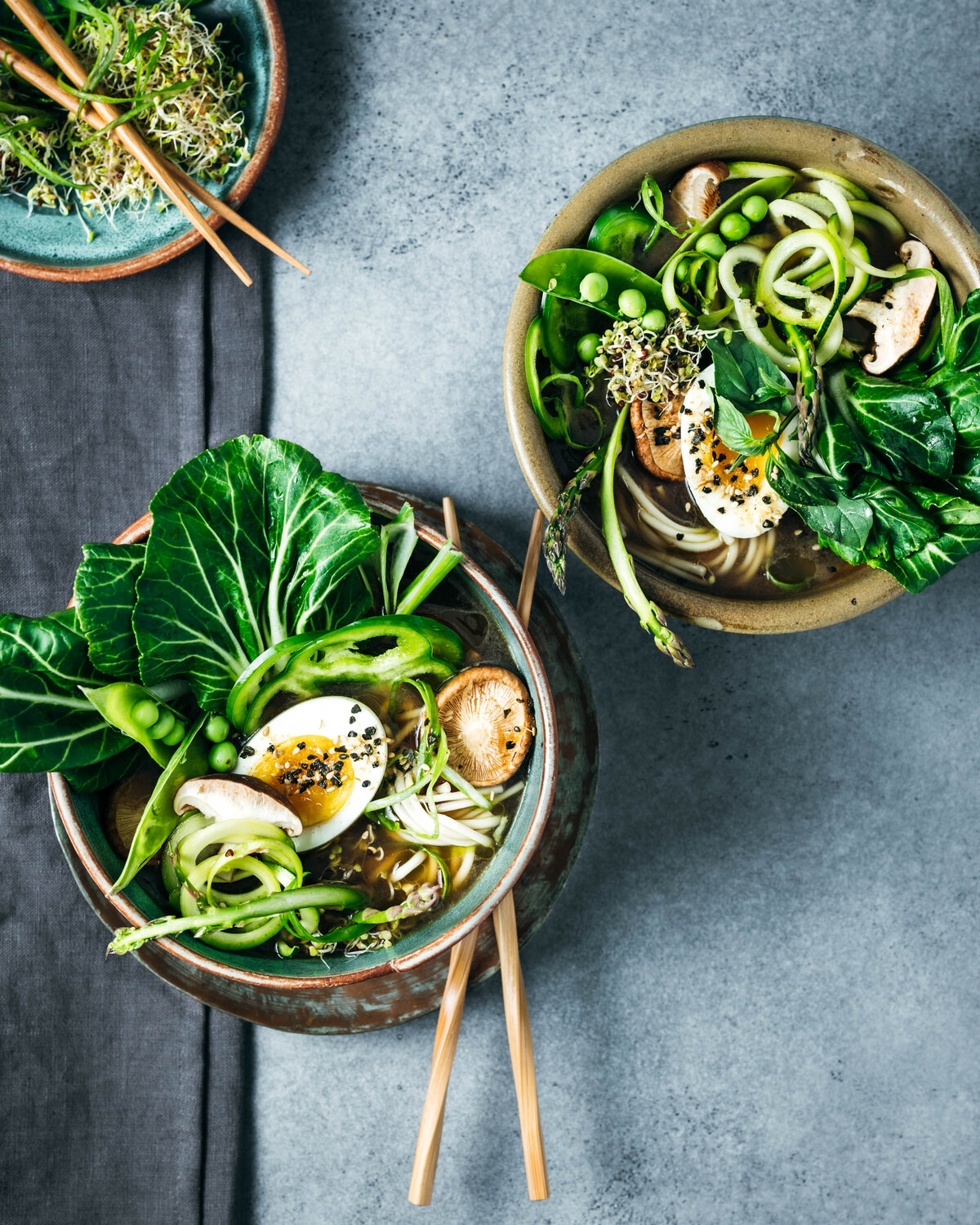 Two bowls of Spring vegetable ramen with soft boiled egg.