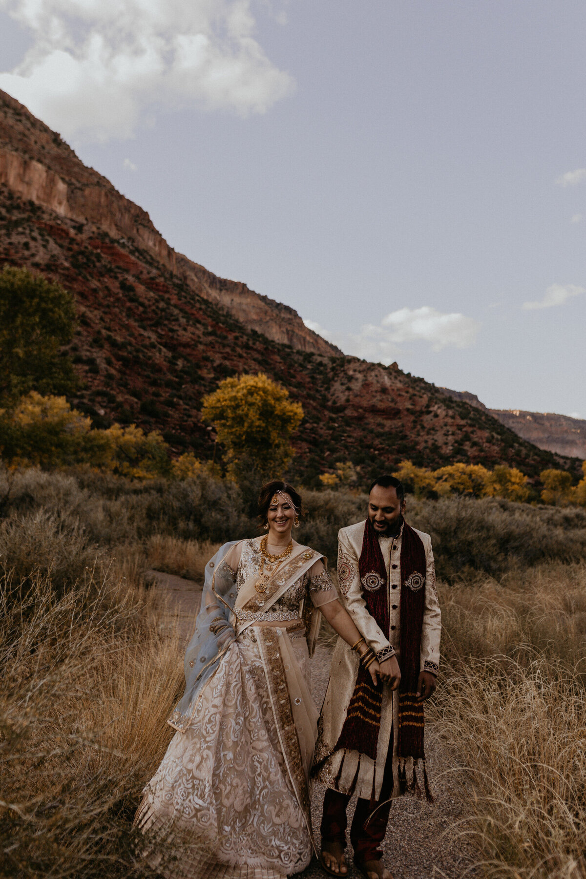 Indian newlyweds walking along the red rocks in Jemez Springs, New Mexico