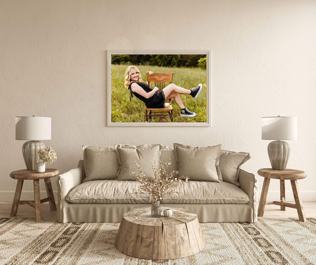 boho and cream colored living room with a gorgeous framed print of a senior on the wall