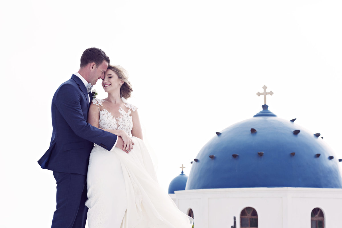 Bride and Groom stood by the Blue Domes in Santorini