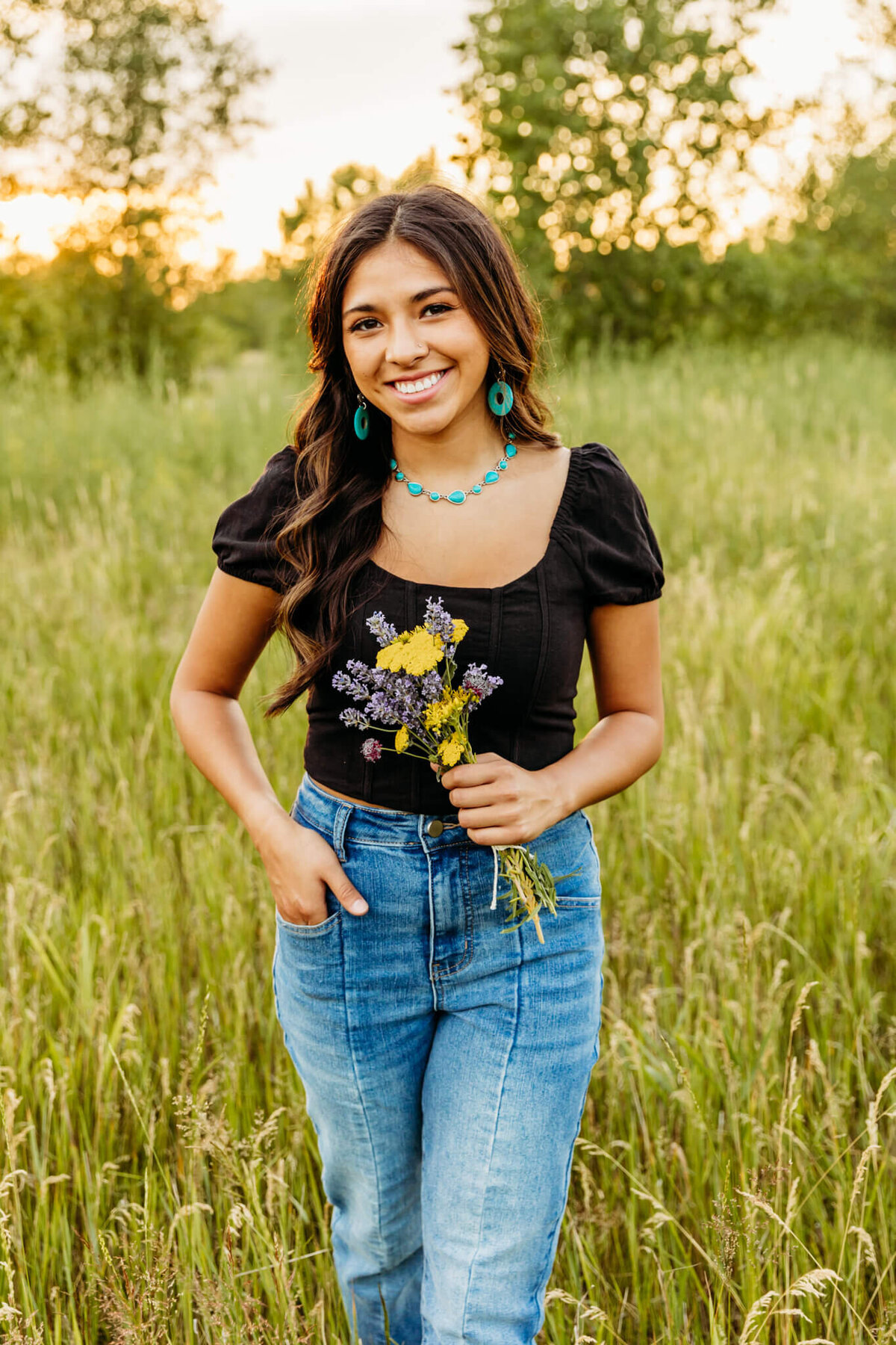 high schooler holding bouquet of flowers and loving her senior photography experience.