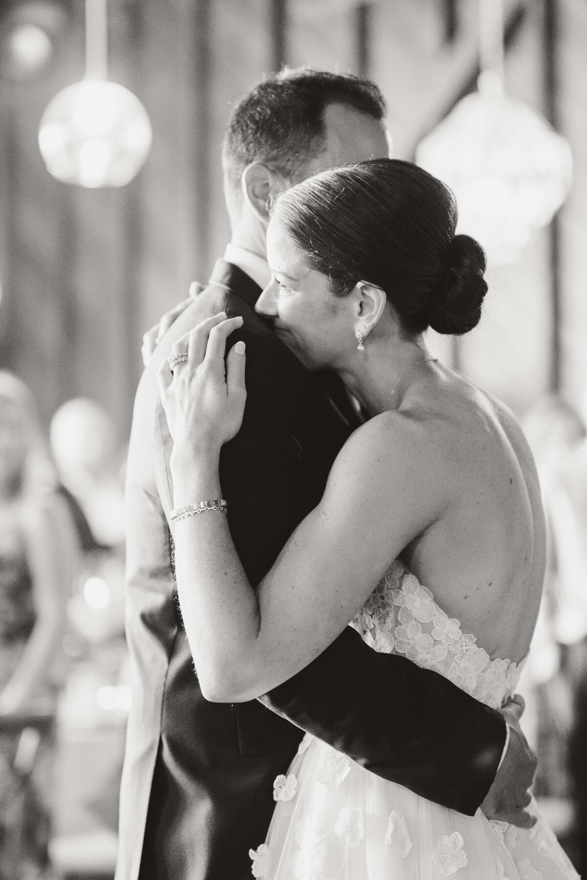 bride and groom hug on dance floor