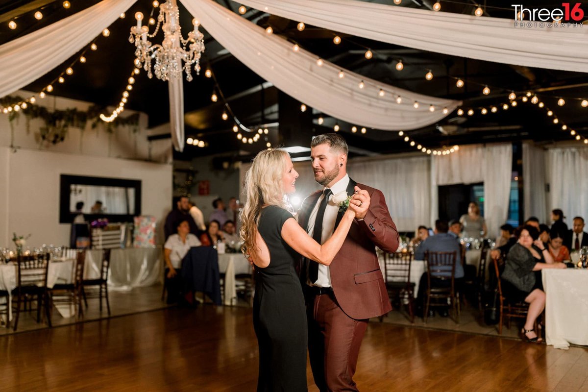 Groom dances with his mother at his wedding reception
