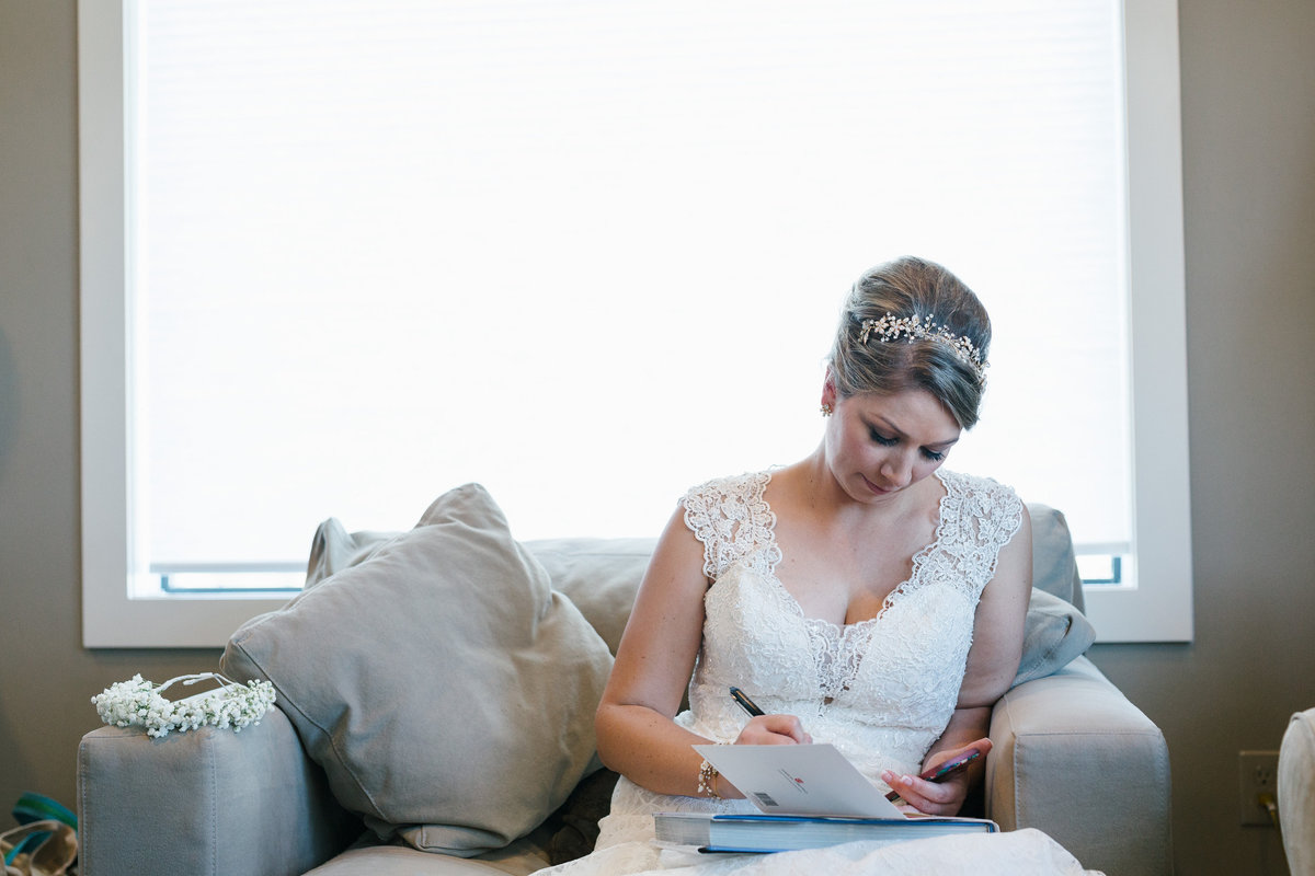 Bride reading a letter from groom before ceremony during getting ready at Paniolo Ranch venue in Texas Hill Country
