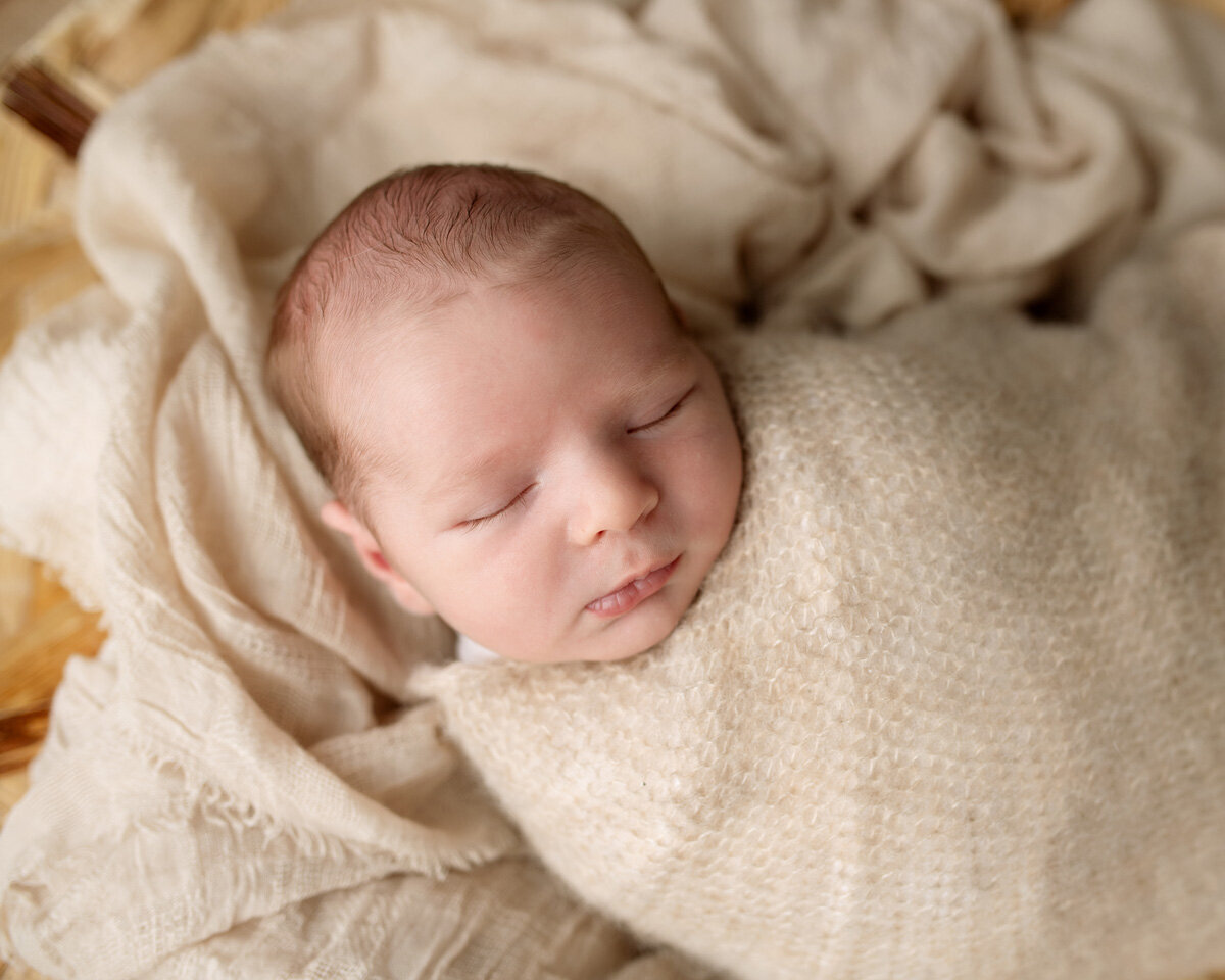 Newborn session of baby swaddled