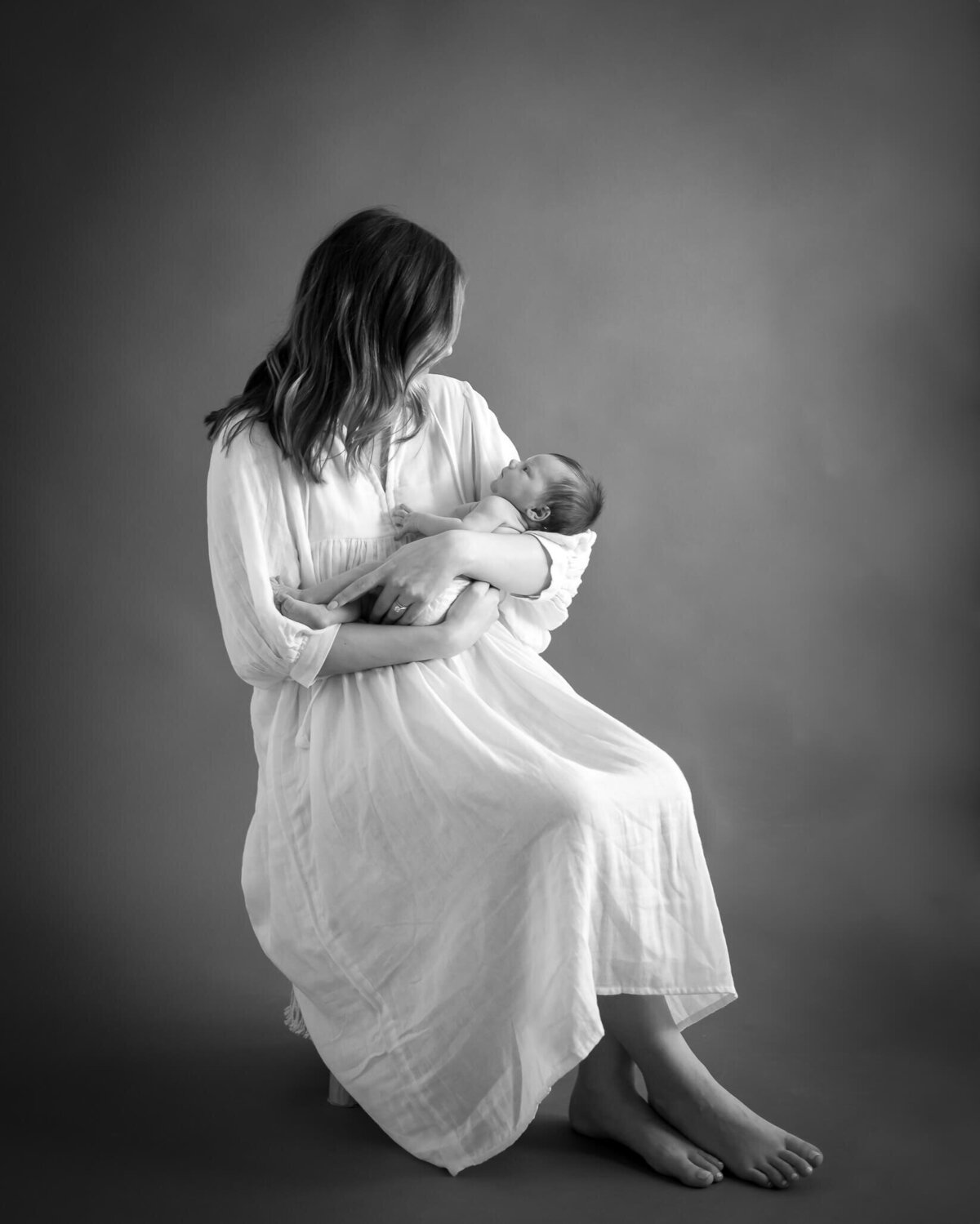 fine art portrait of mom holding baby in black and white