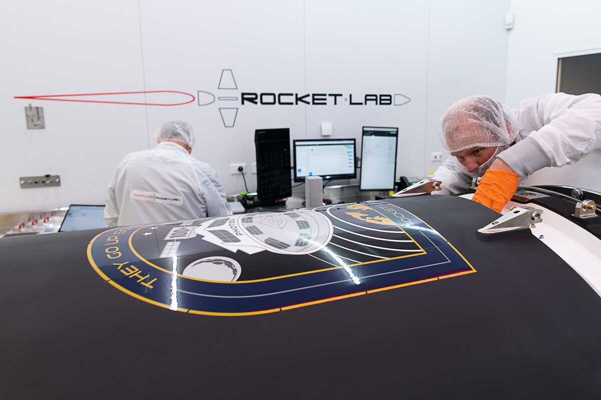 Rocket lab. Engineer sealing nosecone after satellite integration.